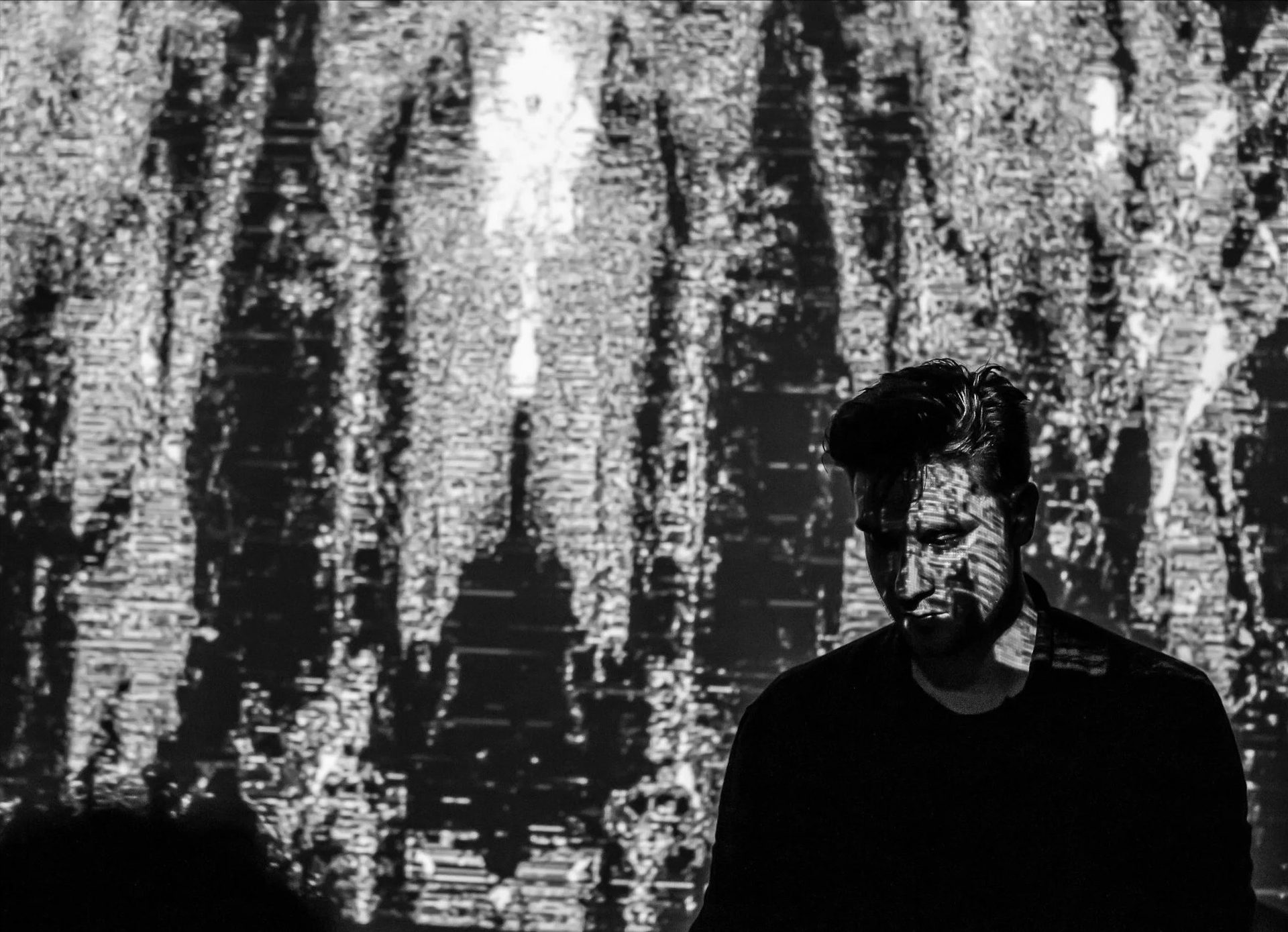 Night Shining performing live in front of a projected generative visual